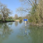 Channel sign reflected in the river
